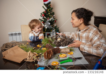 Family Decorating Scene: Mother and Child Making Christmas Crafts at Home Family Decorating Scene: Mother and Child Making Christmas Crafts at Home 133216148
