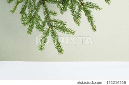 Fir branches on a green and white background. Fir branches on a green and white background. 133216336