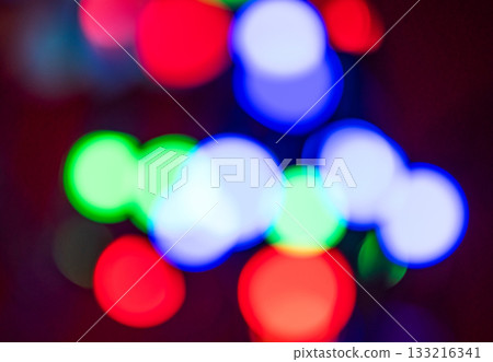Red, blue and green lights with a bokeh effect on a dark background close up. Red, blue and green lights with a bokeh effect on a dark background close up. 133216341