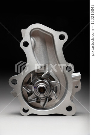 Engine cooling pump, engine coolant pump for a passenger car on a black gradient background. Selective focus 133216842