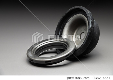 A new two-piece front strut support bearing. The new part is shown on a black gradient background. 133216854