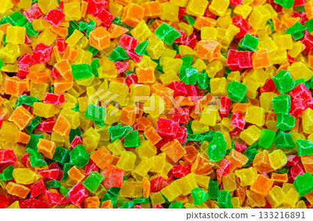 A healthy and delicious snack made from colorful dried fruit pieces. Beautiful colorful candied fruits on a store shelf. Delicious soft-focus background A healthy and delicious snack made from colorful dried fruit pieces. Beautiful colorful candied fruits on a store shelf. Delicious soft-focus background 133216891