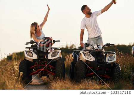 Making a selfie. Man and woman are on ATV outdoors Making a selfie. Man and woman are on ATV outdoors 133217118