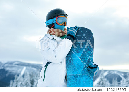 Snowboarder Of Woman At Ski Resort On The Background Blue Sky,  Hold Snowboard. Wearing Ski Glasses. Ski Goggles 133217295