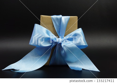 Gift Box with blue ribbon on black background 133217411