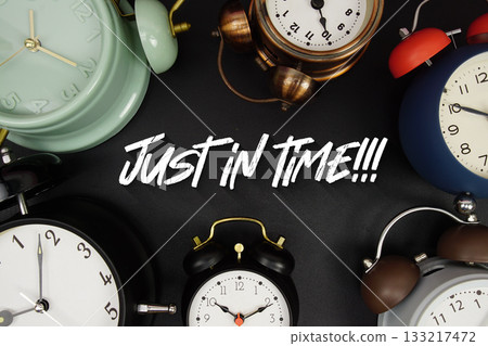 Just in Time text with alarm clock on black background 133217472