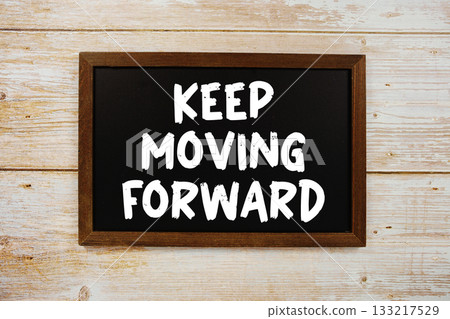 Keep Moving Forward text with gift box present and alarm clock on black background Keep Moving Forward text with gift box present and alarm clock on black background 133217529