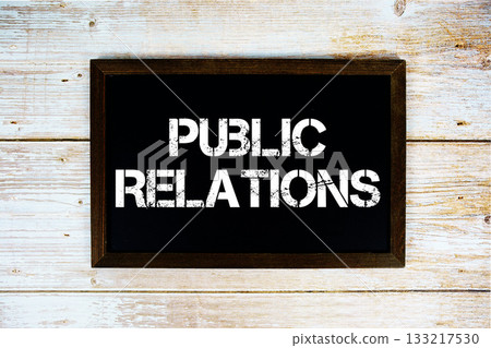 Public Relations text with gift box present and alarm clock on black background Public Relations text with gift box present and alarm clock on black background 133217530