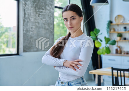 Portrait of confident successful teenage girl posing with crossed arms at home Portrait of confident successful teenage girl posing with crossed arms at home 133217625