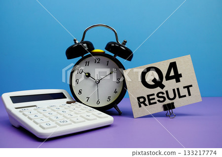Q4 Result text with calculator and alarm clock on blue and purple background 133217774