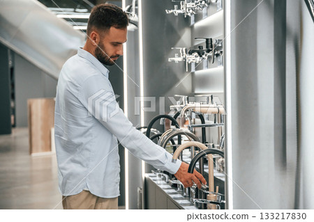 In a room with plumbing equipment. Man is in the hardware shop 133217830