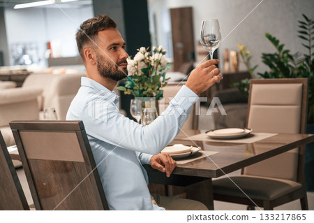Man is sitting in the restaurant with tasty alcohol drink Man is sitting in the restaurant with tasty alcohol drink 133217865