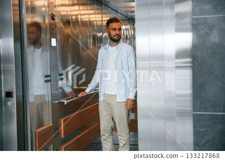 Man in formal clothes is indoors, elevator Man in formal clothes is indoors, elevator 133217868