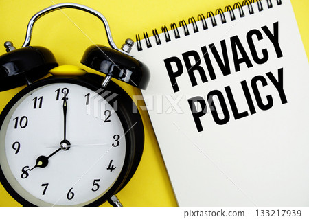 Privacy Policy text with alarm clock flat lay on yellow background Privacy Policy text with alarm clock flat lay on yellow background 133217939