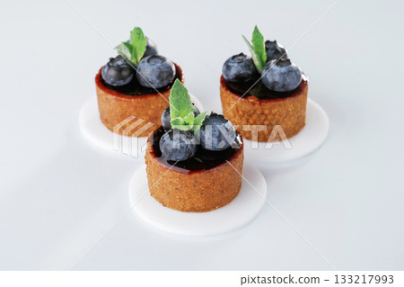 Made by professional baker. Delicious tart with blueberries against white background Made by professional baker. Delicious tart with blueberries against white background 133217993
