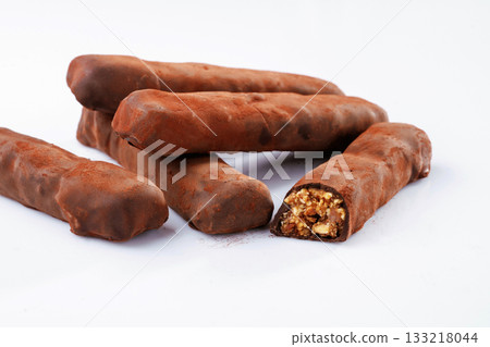 Chocolate bars lie on a white surface, isolated Chocolate bars lie on a white surface, isolated 133218044
