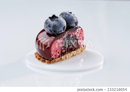 Delicious tart with blueberries against white background Delicious tart with blueberries against white background 133218054