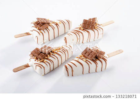 Four objects. Cheesecake that looks like ice cream. Against white background Four objects. Cheesecake that looks like ice cream. Against white background 133218071