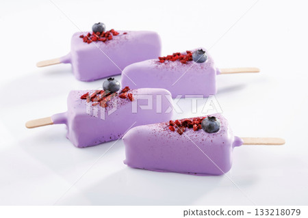 Tasty blueberries on top. Cheesecake that looks like ice cream. Against white background 133218079