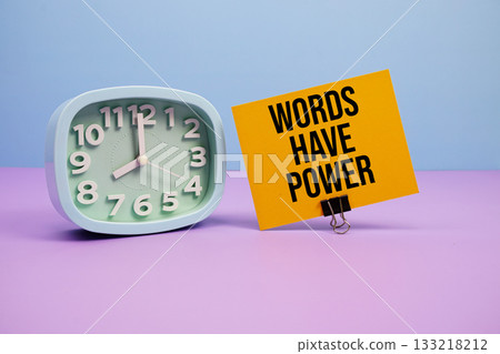 Words Have Power text and alarm clock on blue and purple background Words Have Power text and alarm clock on blue and purple background 133218212