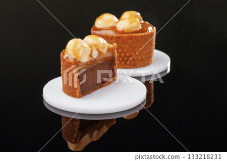 Front view, close up. Delicious cake against black background Front view, close up. Delicious cake against black background 133218231