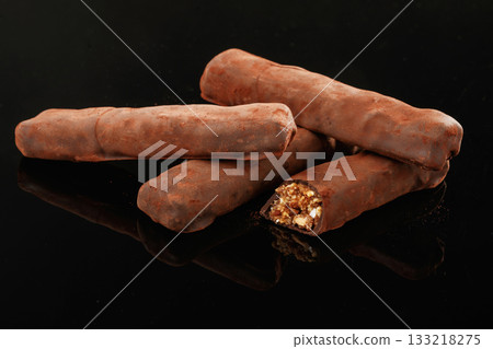 Crispy and sweet chocolate bars on black background 133218275