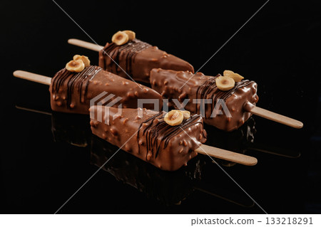 In the form of ice cream. Tasty cheesecakes on the black background In the form of ice cream. Tasty cheesecakes on the black background 133218291