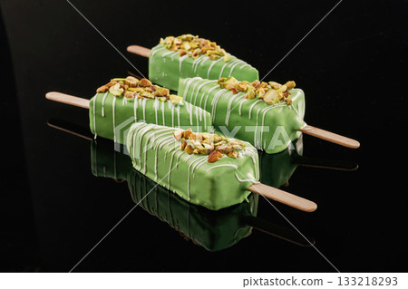 In the form of ice cream. Tasty cheesecakes on the black background In the form of ice cream. Tasty cheesecakes on the black background 133218293