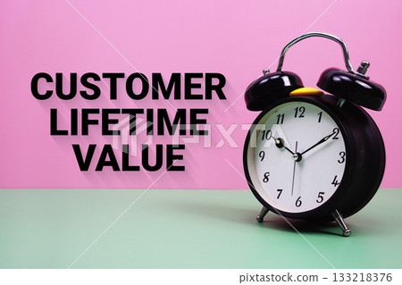 Black alarm clock on a pastel green and pink background with the text "Customer Lifetime Value" Black alarm clock on a pastel green and pink background with the text "Customer Lifetime Value" 133218376