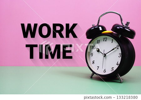 Black alarm clock on a pastel green and pink background with the text "Work Time" 133218380
