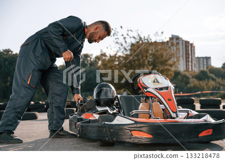 Starting the vehicle. Man is outdoors, kart racing conception 133218478