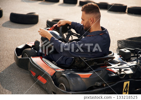 Ready for the competition, driving. Man is outdoors, kart racing conception 133218525