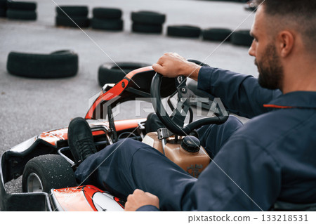 Parked, driving out. Man is outdoors, kart racing conception 133218531