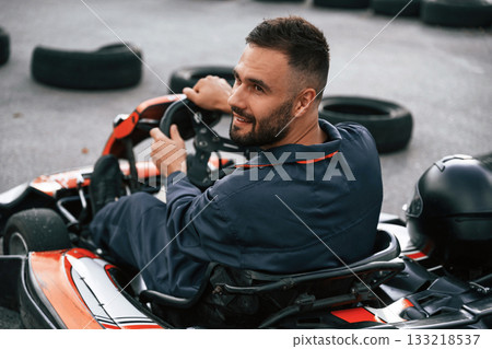 Extreme sports, driving. Man is outdoors, kart racing conception Extreme sports, driving. Man is outdoors, kart racing conception 133218537