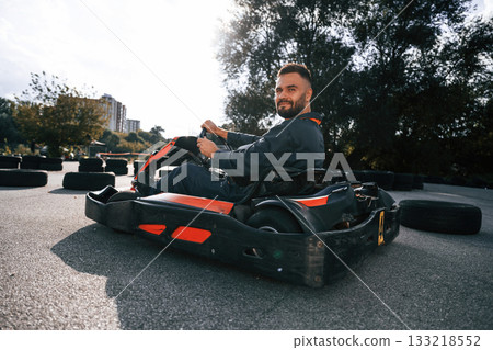 Extreme sports, driving. Man is outdoors, kart racing conception 133218552