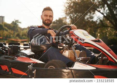 Trees and sunlight. Man is outdoors, kart racing conception 133218585