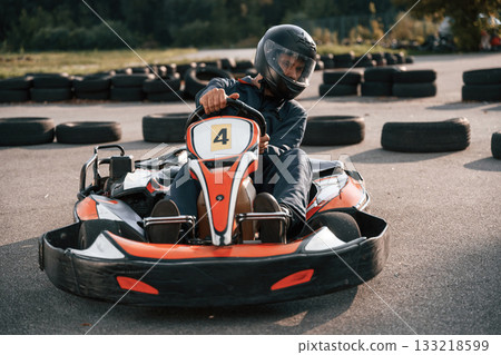 Competition, riding. Man is outdoors, kart racing conception 133218599