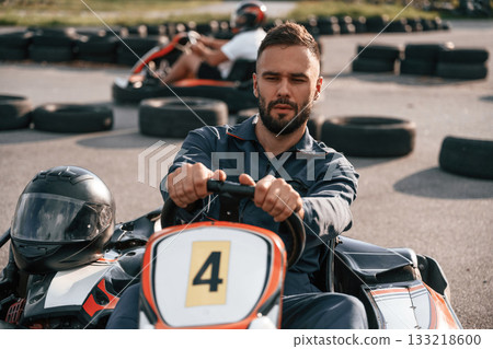 Competition, riding. Man is outdoors, kart racing conception 133218600