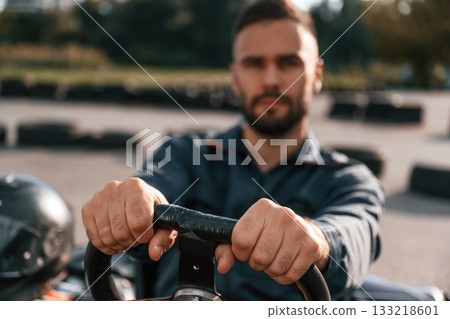 Competition, riding. Man is outdoors, kart racing conception 133218601
