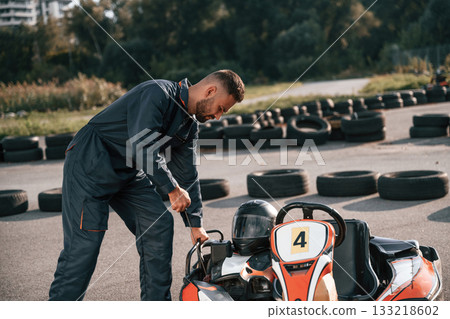 Starting the vehicle. Man is outdoors, kart racing conception 133218602