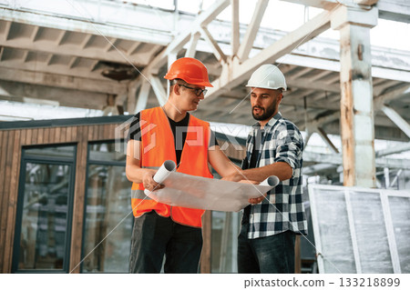 Plan of the building, architecture. Two workers are in the industrial wooden warehouse Plan of the building, architecture. Two workers are in the industrial wooden warehouse 133218899