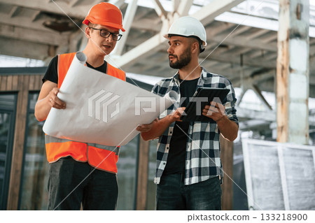 Plan of the building, architecture. Two workers are in the industrial wooden warehouse Plan of the building, architecture. Two workers are in the industrial wooden warehouse 133218900