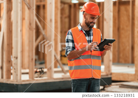 Manager is with digital tablet. Industrial worker in wooden warehouse 133218931