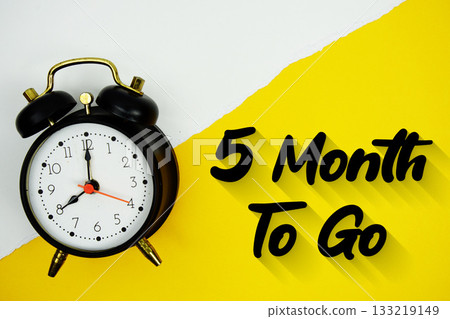 5 Month To Go text and alarm clock on yellow background 5 Month To Go text and alarm clock on yellow background 133219149