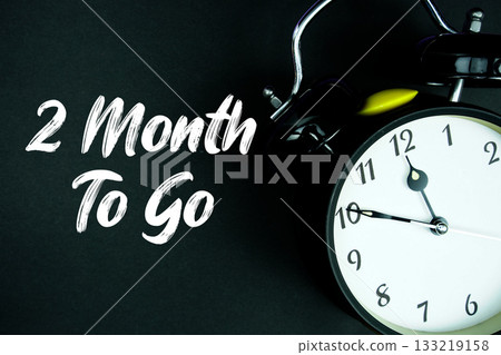 2 Month To Go text and alarm clock on black background 133219158