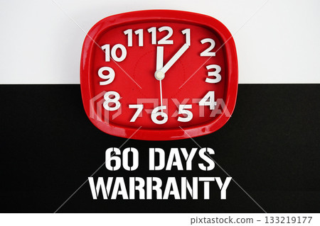 60 Days Warranty text and alarm clock on black and white background 133219177