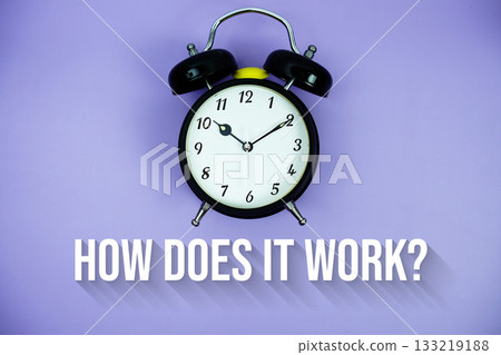 How Does It Work? text and alarm clock on purple background 133219188
