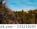 Ancient monastery nestled in autumn forest landscape under blue sky. Monasterio de Piedra 133219285