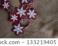 Festive Red and White Star Decorations on Burlap Background 133219405
