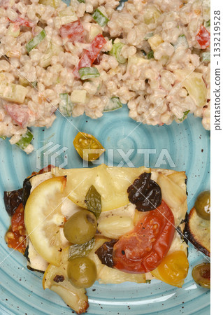 Baked tofu dish with barley salad 133219528
